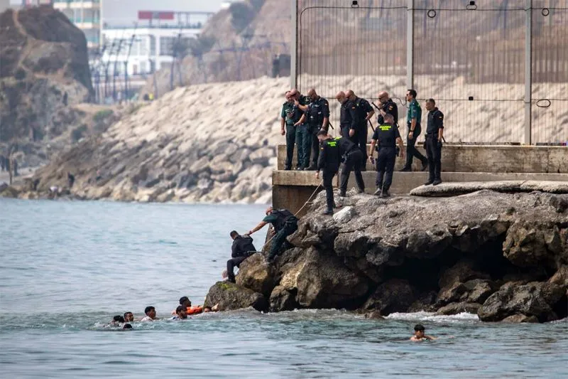 Thousands of people break through border separating Morocco from Spain's Ceuta